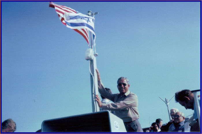 Our Arab tour guide standing by the boat's flag mast